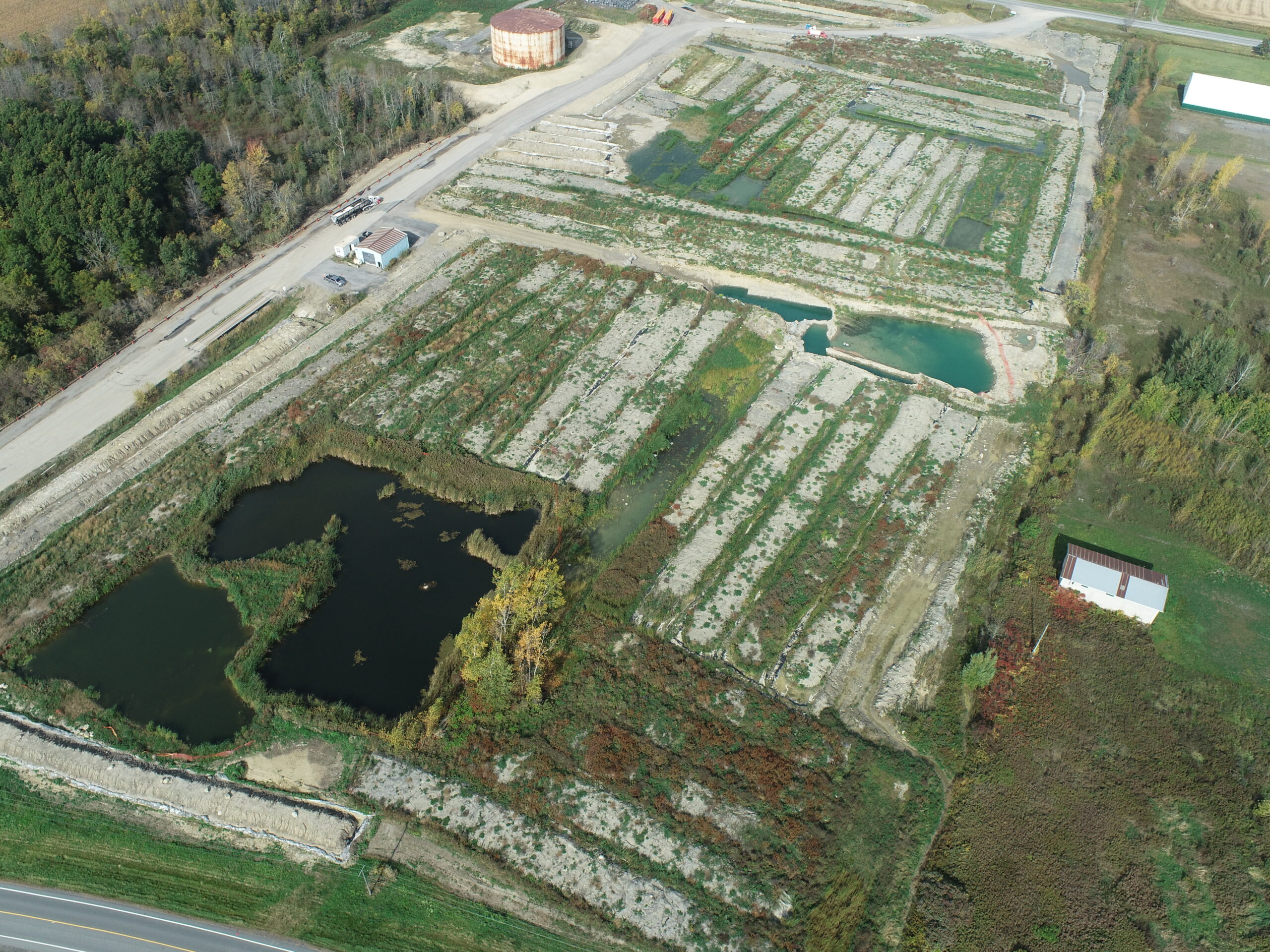 Aerial overview of an environmental site with ponds and biopiles